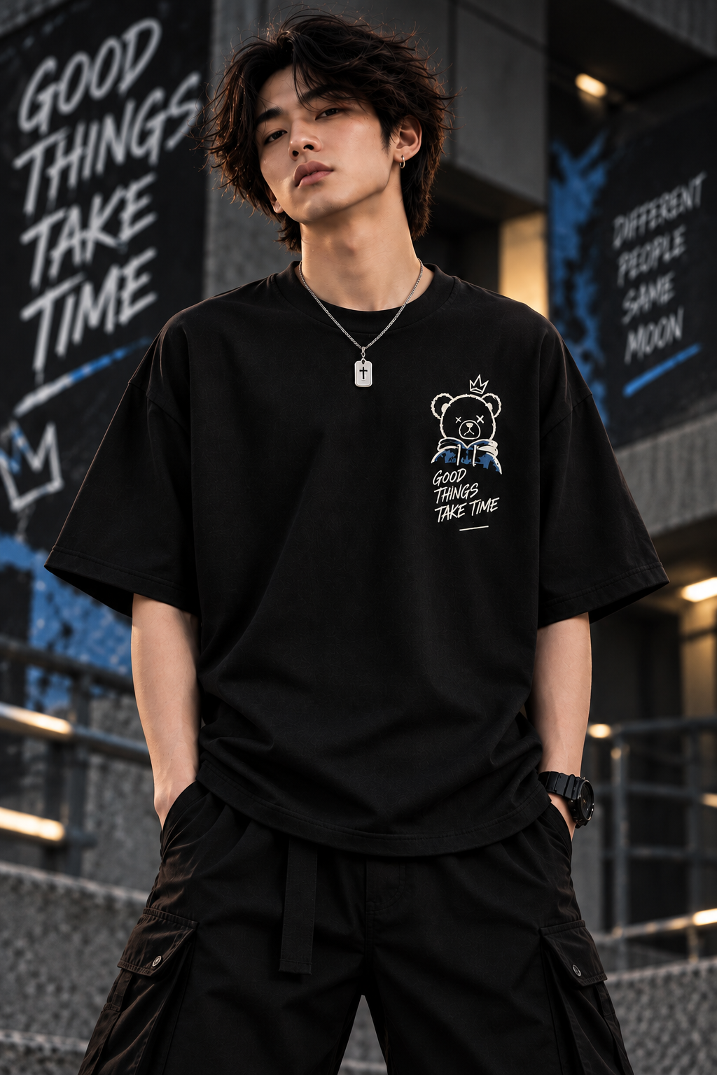 Model wearing black oversized teddy bear graphic t-shirt with Good Things Take Time design