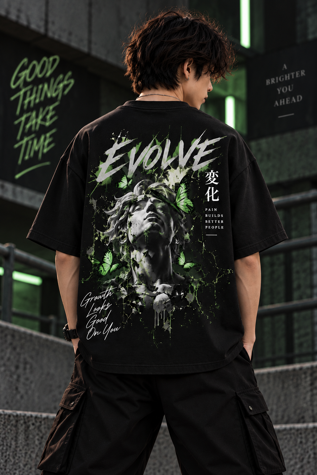 Model wearing black oversized Evolve graphic t-shirt with butterfly and portrait back design